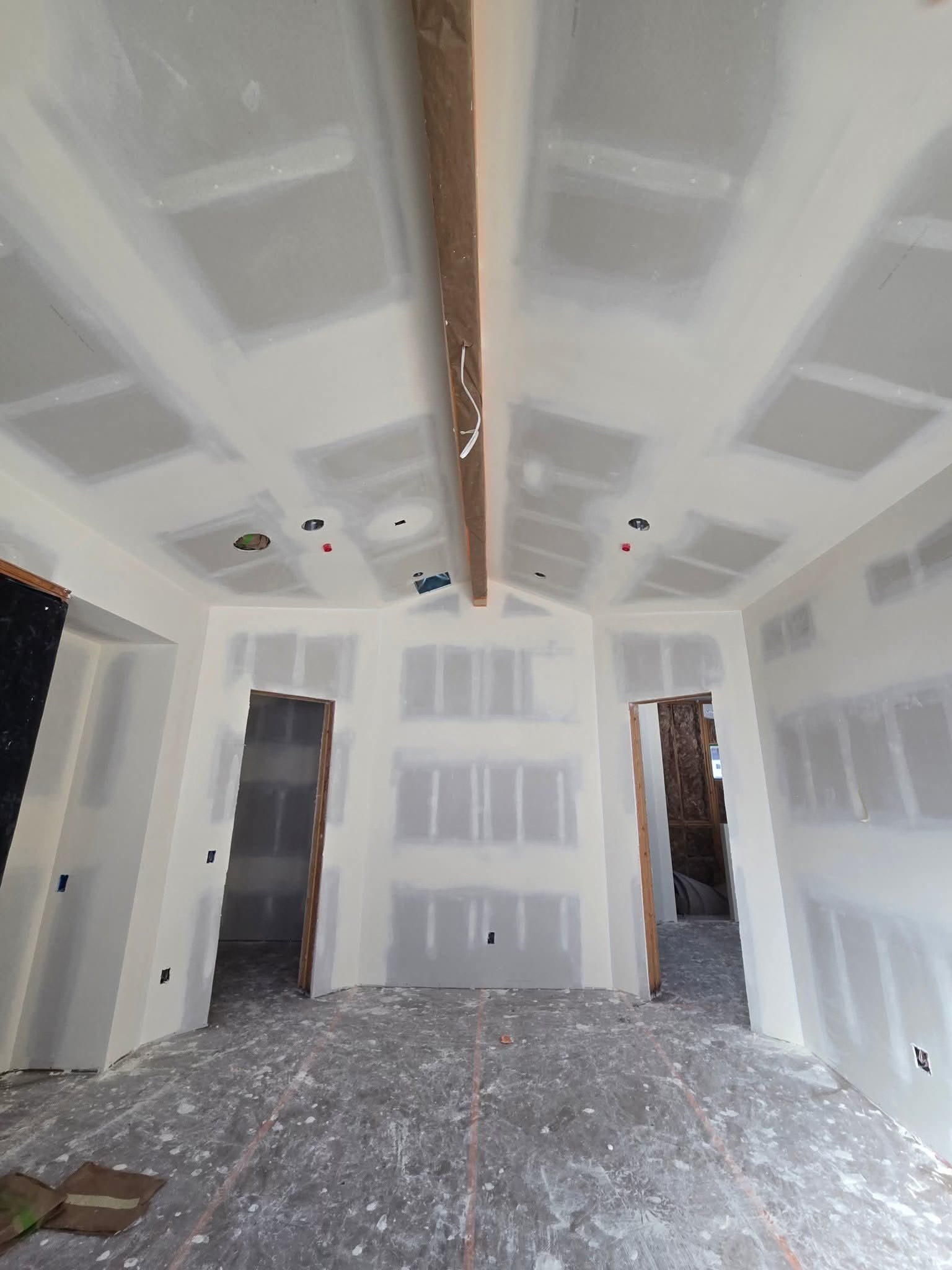 Finished drywall with taped joints and vaulted ceiling — quality finishing work