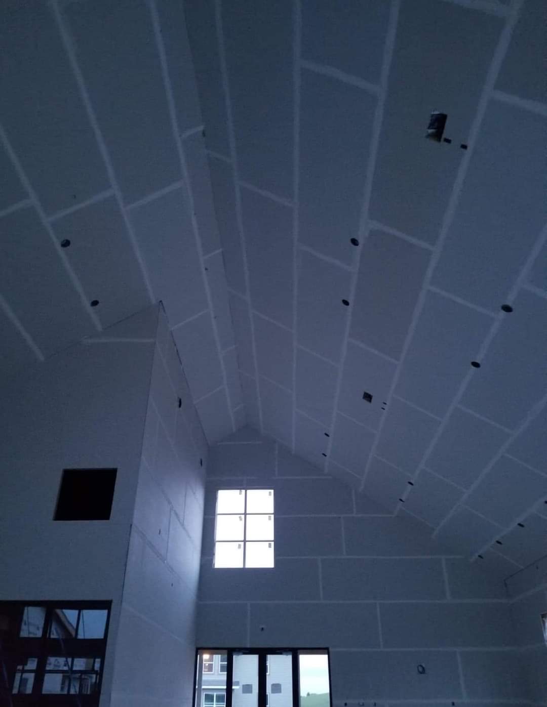 Large cathedral ceiling fully drywalled — impressive scale project